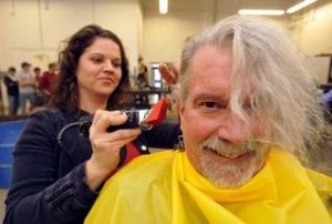 Scott Stekly, a welding student at MSU-Great Falls, gets a buzz cut by classmate Rachel Kaiser Wednesday in the welding shop. (TRIBUNE PHOTO/ RION SANDERS)